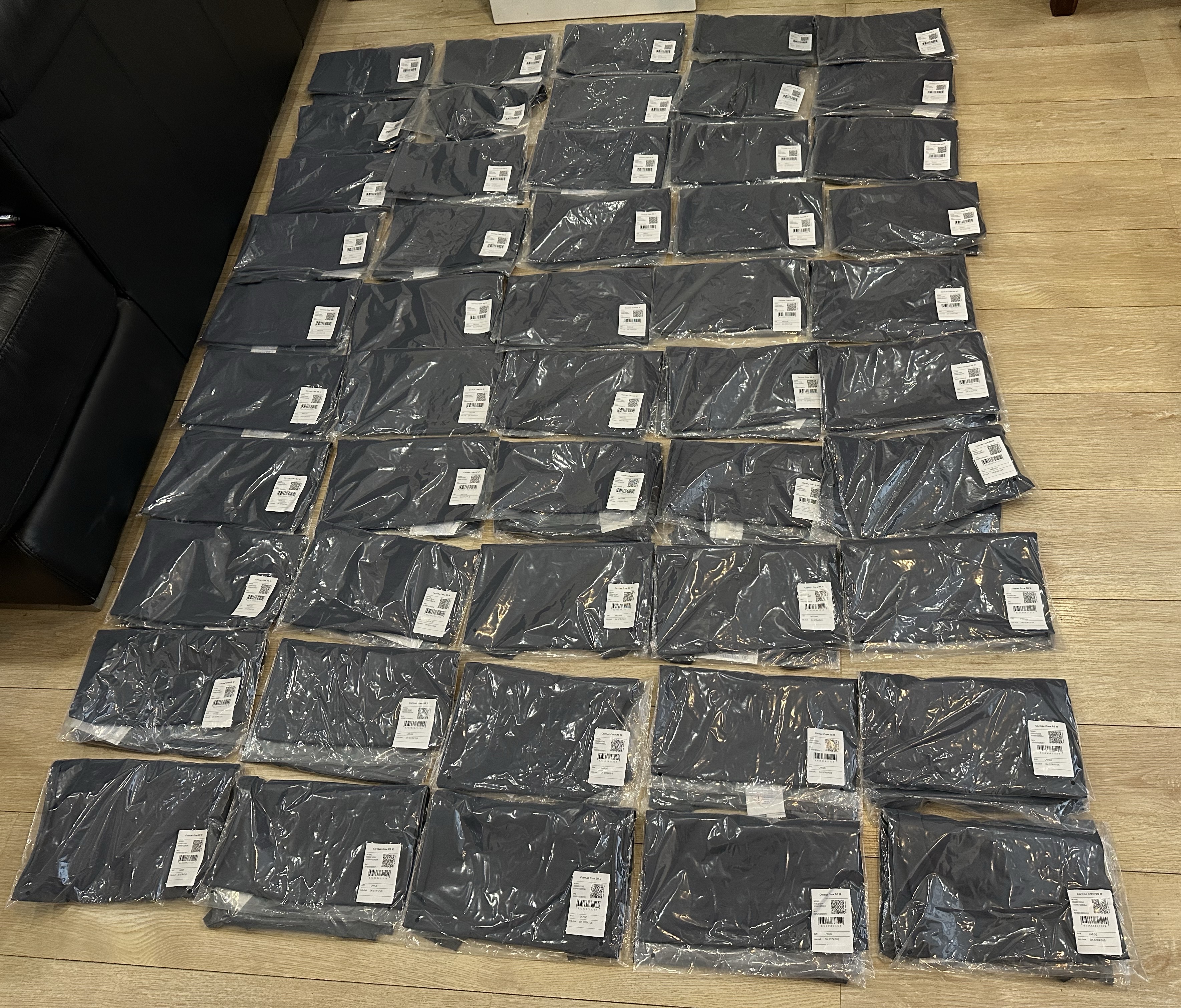 Rows of individually packed dark apparel