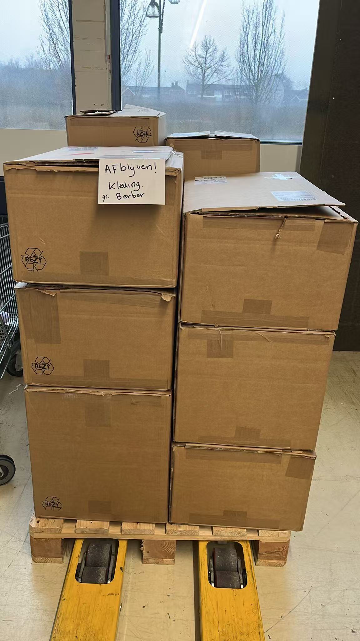 A labelled stack of cartons staged on a pallet truck for dispatch
