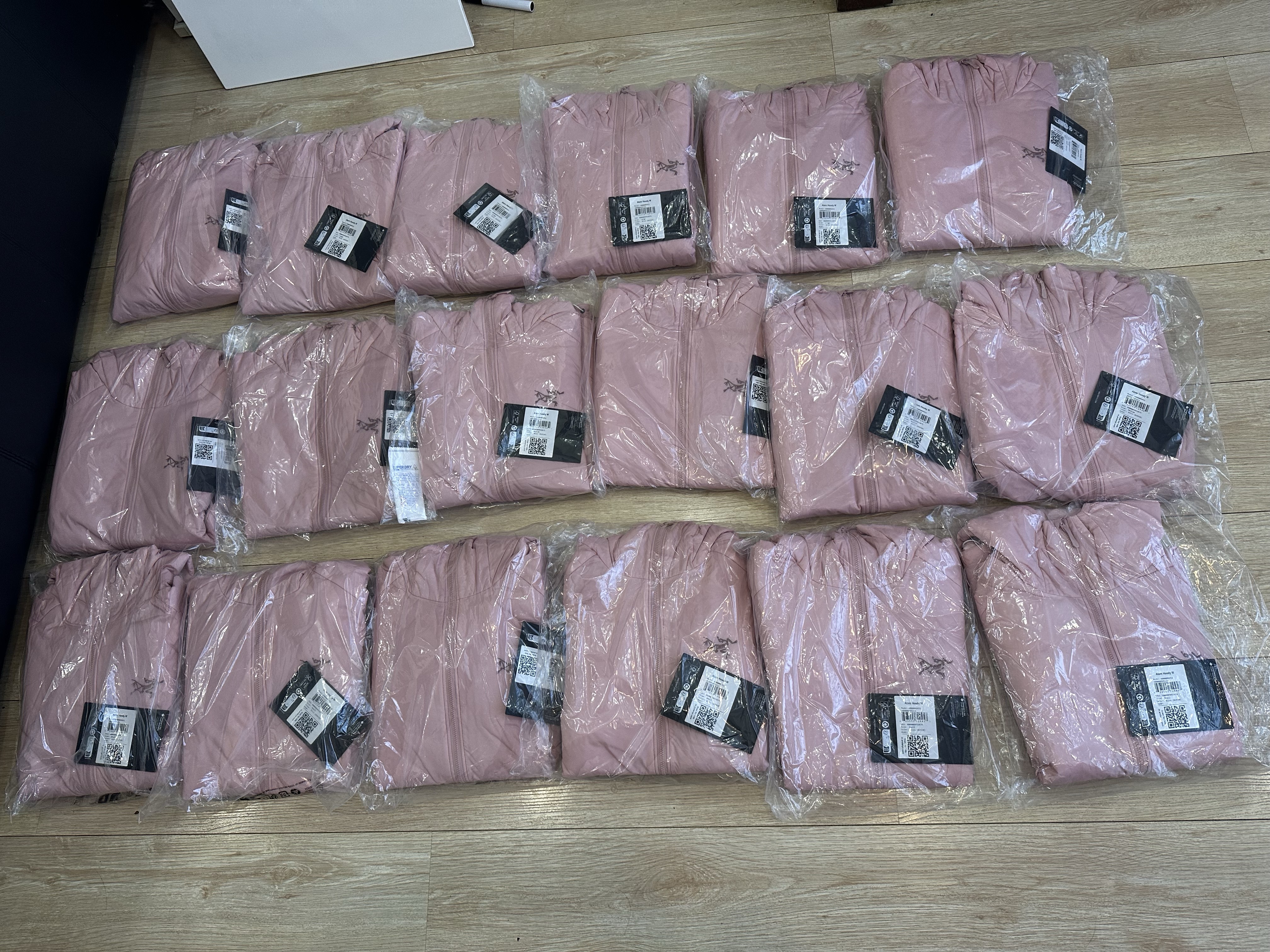 Pink outerwear pieces individually packed for a wholesale order