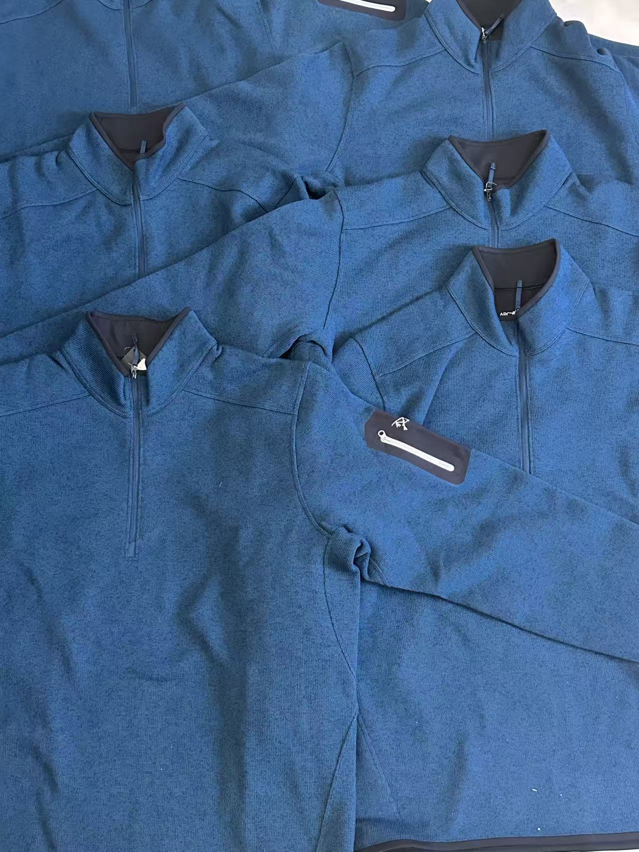 Blue zip knitwear arranged as a coordinated selection