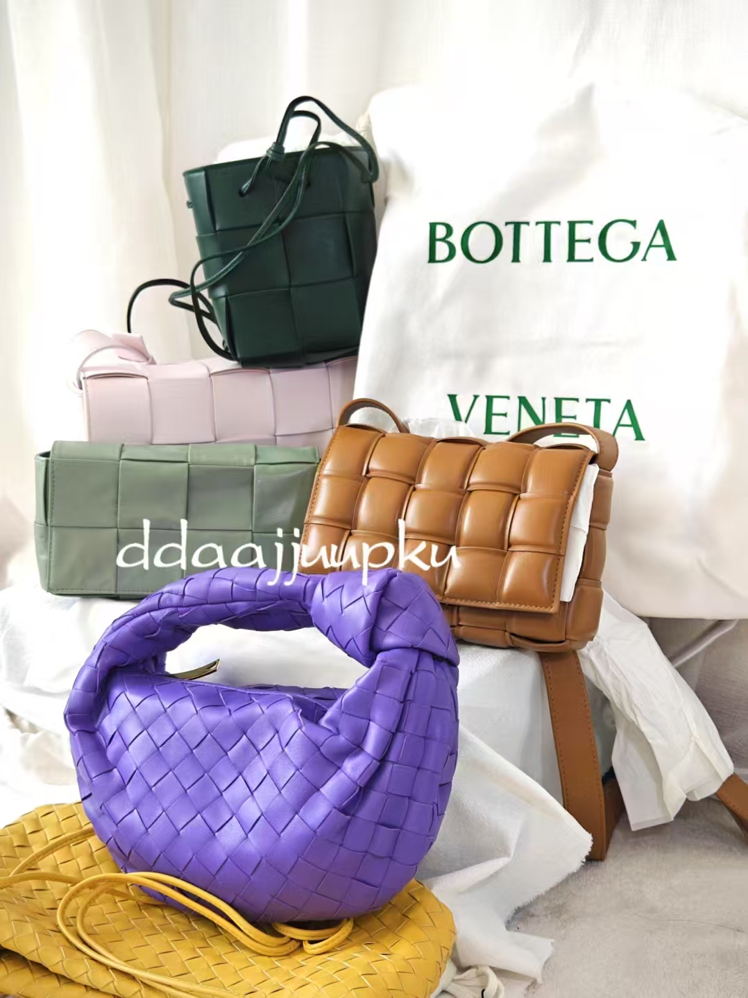 A curated group of woven bags in green, pink, tan and purple